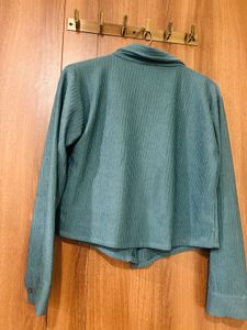 This is a teal-green pleated long-sleeve collared
