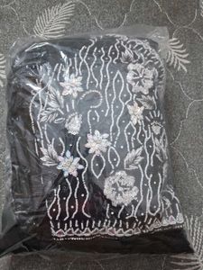 Selling a black color partywear stitched saree