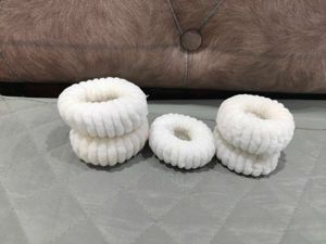 A set of 5 white thick rubberbands