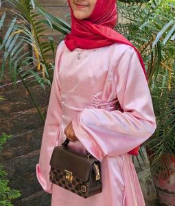 Elegant Pink Gown with Red Scarf