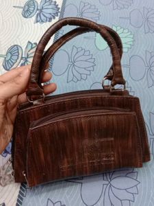 2 Racerback Sports Bras + brown handbag.