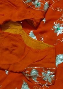 Elegant Orange Saree with Silver Embellishments