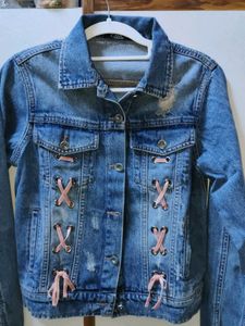 Distressed Denim Jacket with Pink Lace-Up Detail