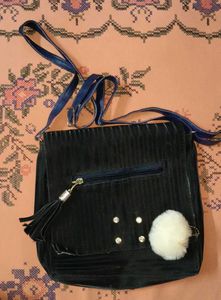 Chic Black Crossbody Bag with Pom Po