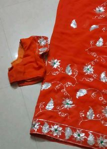 Elegant Orange Saree with Silver Embellishments