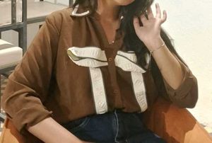 Brown shirt pattern top with bow in front