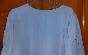 Elegant Light Blue Top with Embellished Sleeve