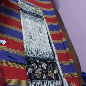 beautiful checked cream saree with black print border