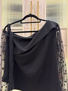 Chic Black Top with Polka Dot Sleeves