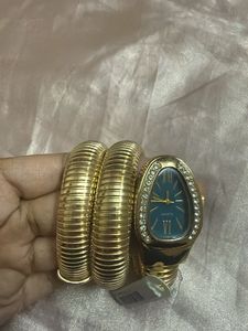 Elegant Gold Tone Coil Watch with Blue Dial