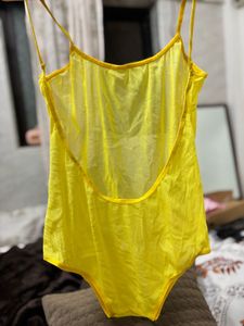 Yellow one-piece swimsuit with a deep scoop back