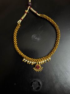 Elegant Gold Tone Necklace with Red Stone
