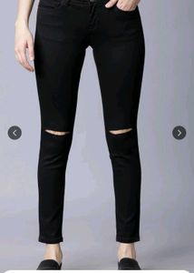 Black skinny jeans with knee slits