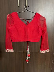 Vibrant Red Saree with Intricate Embellishments