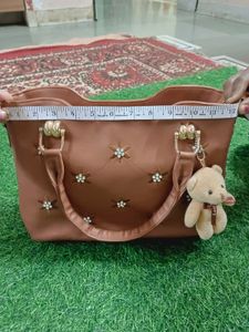 Elegant Brown Handbag with Floral Accents