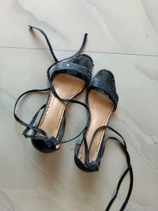 used worn black tie up heels