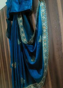 Elegant Teal Saree with Gold Embellishments