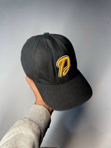 Black baseball cap with yellow 'D' logo