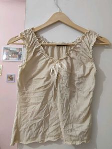 Cream ruched tie-front sleeveless top