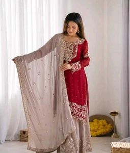 elegant red kurti set with black jhumka .