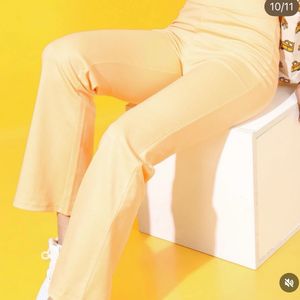 Yellow stretchable flared cotton trousers.