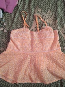 orange coloured sleeveless top
