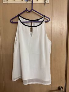 Chic White Sleeveless Top with Black Trim
