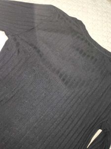 The image features a black ribbed top characterize
