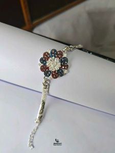 Pure Silver Designer Rakhi with Floral Embellishme