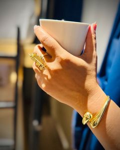 Elegant Gold Feather Ring & Bangle Set