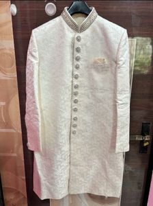 Men’s white sherwani with red velvet dhoti