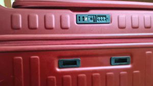 Maroon Hard Shell Luggage Handel grip is broken