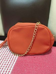 Chic Orange Crossbody Bag with Gold Chain
