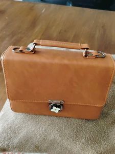 Stylish Tan Handbag with Flower Clasp