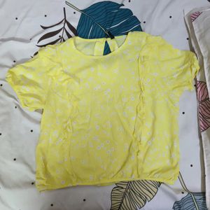 A Yellow Colour Top With Frills In The Front