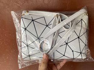 Brand new Ladies White sling bag in black design.