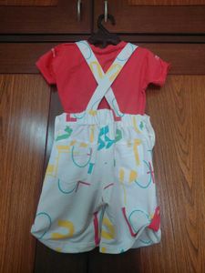 white dungaree with orange tshirt