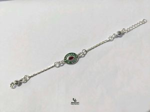 Elegant Pure Silver Rakhi with Red and Green Stone