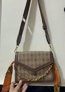 Chic Monogram Shoulder Bag with Scarf Accent