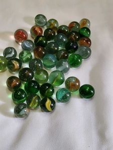 40 pieces colourful shiny glass marbles.