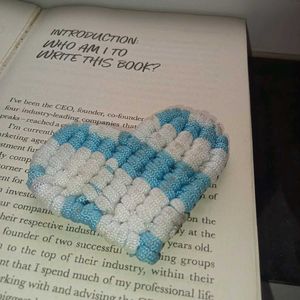 Heart-shaped bookmark on book page