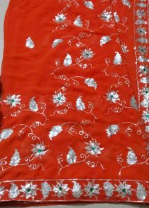 Elegant Orange Saree with Silver Embellishments