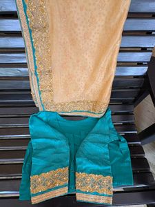 cream colour saree with peacock blue blouse