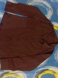 brown shirt with black buttons