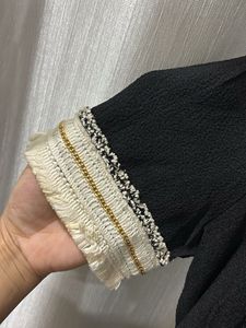 Elegant Black Dress with Embellished Neckline