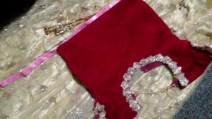 The maroon  lehenga   with golden colour net gown