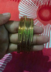 Set of 4 Gold Tone Bangles with Charms