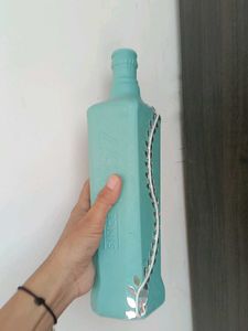 Decorative Teal Bottle with Vine Accent