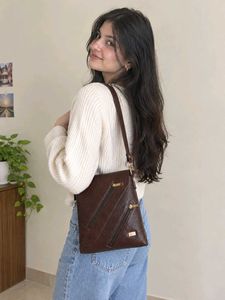 coffee brown coloured sling leather bag