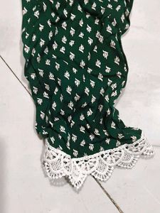 A beautiful dark green short kurti with embellish